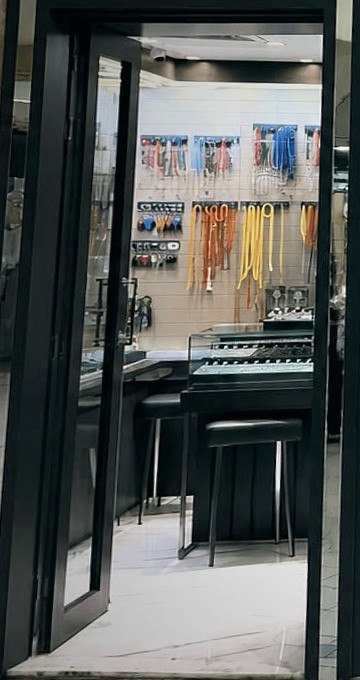 Inside the boutique — chain wall and fitting counter